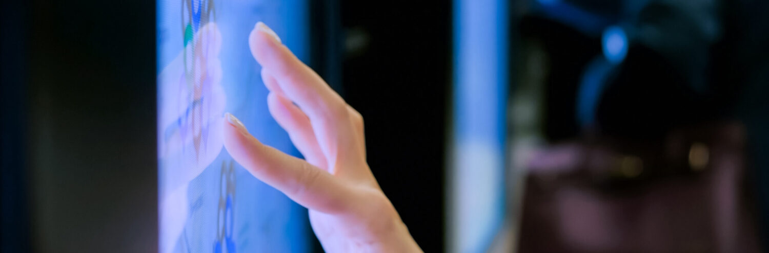 Hand, die auf Bildschirm tippt.